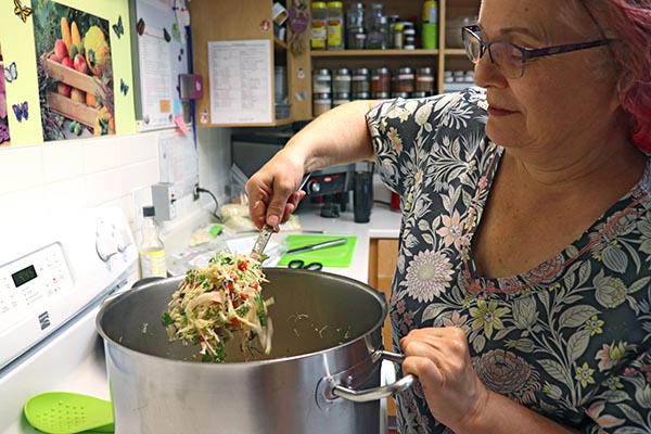 YWCA Nutrition Specialist preparing food for childcare programs 